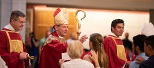 Bishop Michael F. Burbidge places chrism on a confirmand at the Cathedral of St. Thomas More in Arlington June 9.